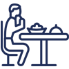 Person sitting at dental office table with covered dishes, representing dining or consultation setting.