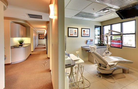 Modern dental office reception area and treatment room with contemporary furniture and equipment in Palm Desert.